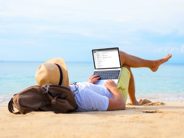 Man using a Laptop on a Beach