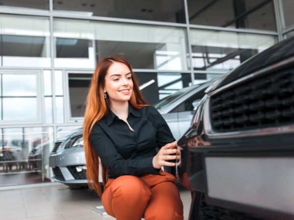 Woman Inspecting a Car