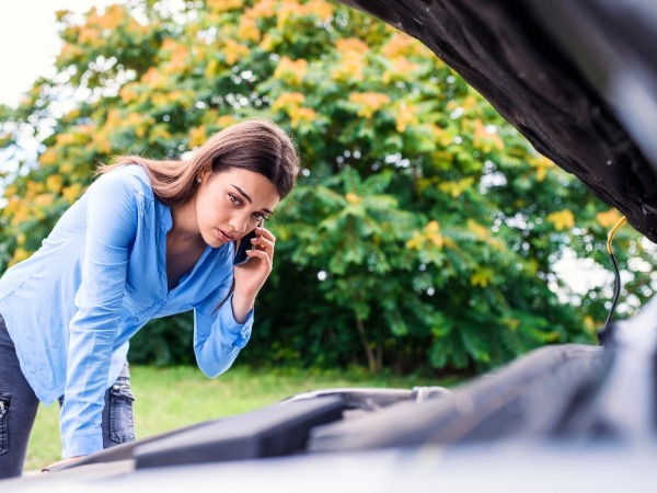 Woman in Front of a Broken Car
