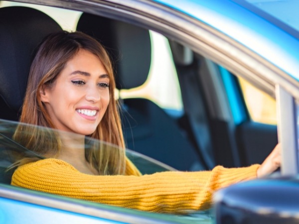 Woman Driving a Blue Car
