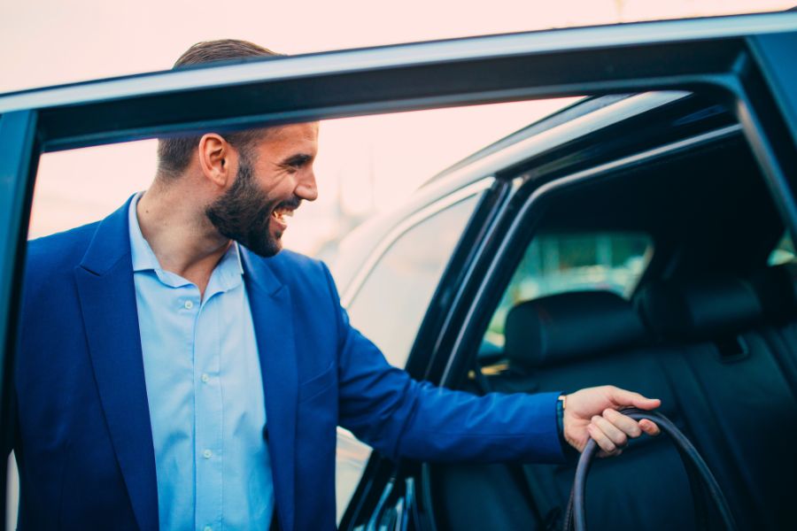 Woman waiting for rental car in front of the Airport