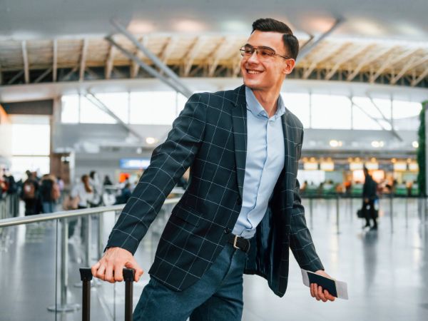 Happy man walking throught he airport