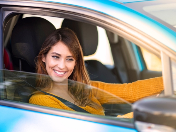 Woman Driving a Blue Car